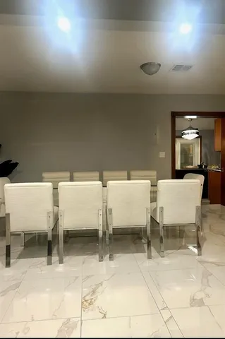 a living room with couches and white walls