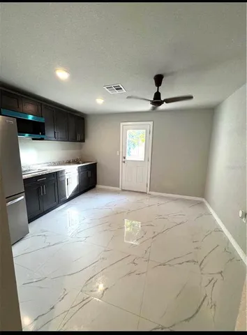 a view of kitchen with stainless steel appliances kitchen island sink and stove