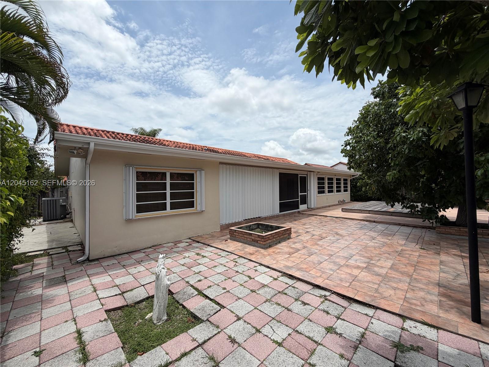 3262 Southwest 139th Place Miami, FL 33175 - Photo 32 of 36 a backyard of a house with table and chairs