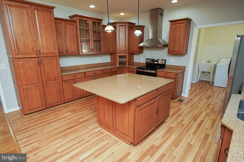30980 Rehobeth Road Westover, MD 21871 - Photo 11 of 36 a kitchen with stainless steel appliances granite countertop a stove a sink dishwasher and a refrigerator with wooden floor