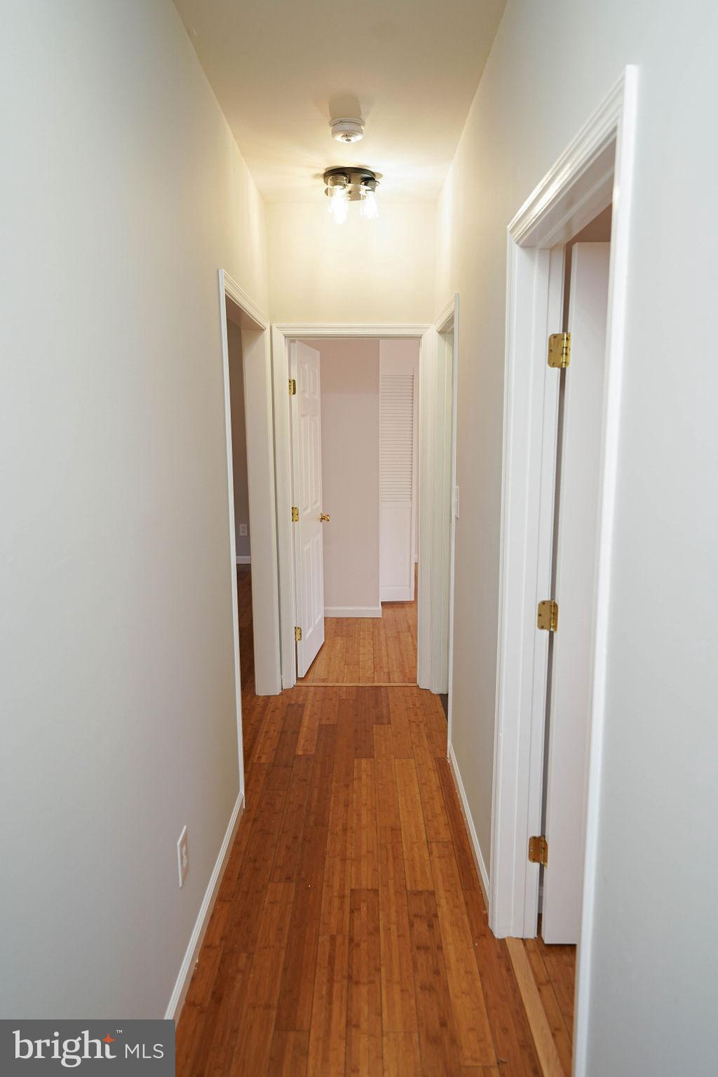 30980 Rehobeth Road Westover, MD 21871 - Photo 16 of 36 a view of a hallway with wooden floor and a bathroom