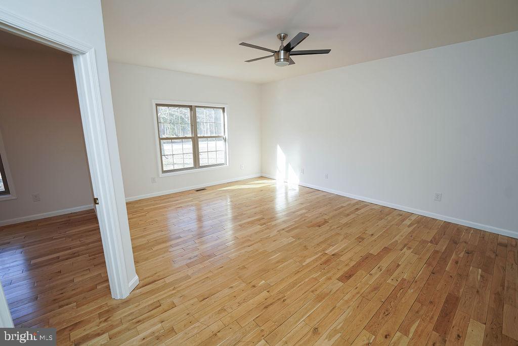 30980 Rehobeth Road Westover, MD 21871 - Photo 24 of 36 a view of empty room with wooden floor and fan