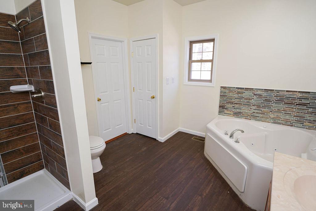30980 Rehobeth Road Westover, MD 21871 - Photo 27 of 36 a bathroom with a tub a sink and a window