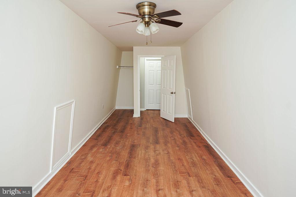 30980 Rehobeth Road Westover, MD 21871 - Photo 33 of 36 a view of a hallway with wooden floor and chandelier fan