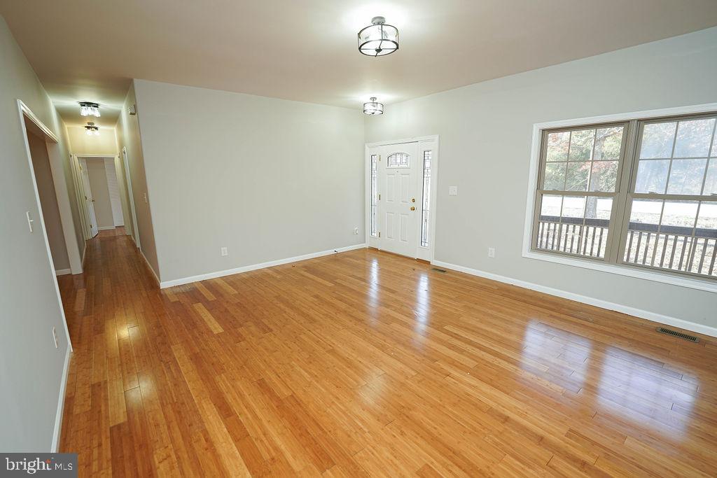 30980 Rehobeth Road Westover, MD 21871 - Photo 6 of 36 an empty room with wooden floor and windows