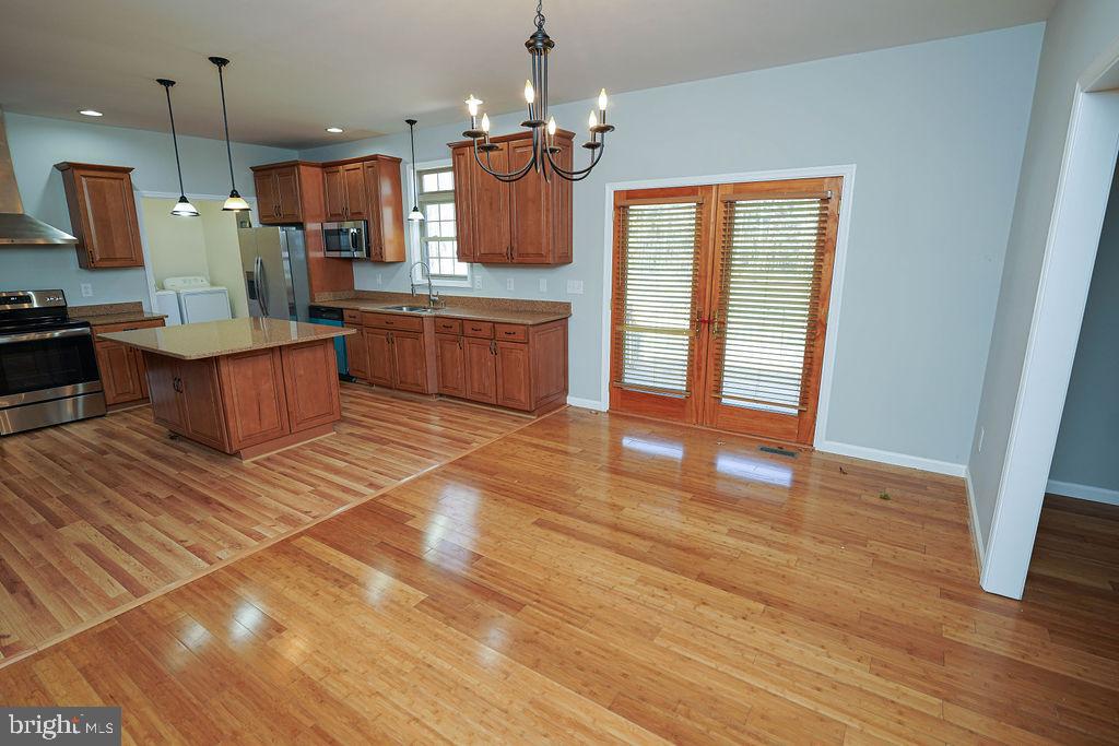 30980 Rehobeth Road Westover, MD 21871 - Photo 8 of 36 a large kitchen with stainless steel appliances kitchen island granite countertop a stove a sink and a refrigerator