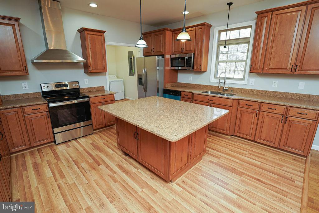 30980 Rehobeth Road Westover, MD 21871 - Photo 9 of 36 a kitchen with stainless steel appliances granite countertop a sink a stove and a wooden floors