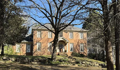 a view of a large house with a yard
