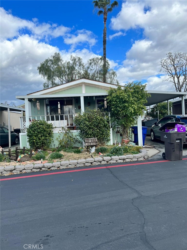 3701 Fillmore Street, Unit 148 Riverside, CA 92505 - Photo 1 of 1 a front view of a house with a yard and trees