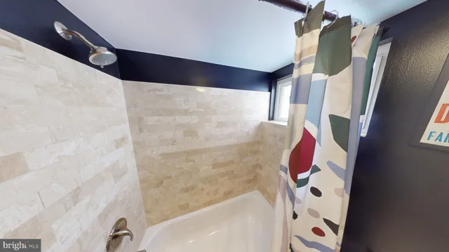 a bathroom with a bathtub and shower