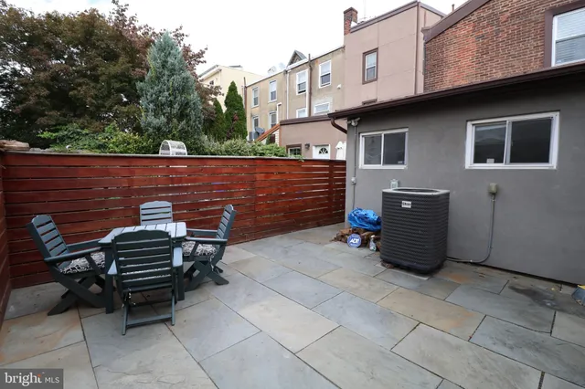 a view of a chairs and table in the backyard