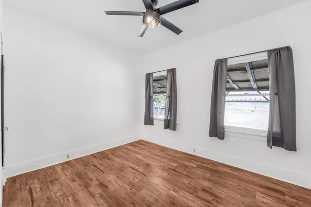 an empty room with windows and closet