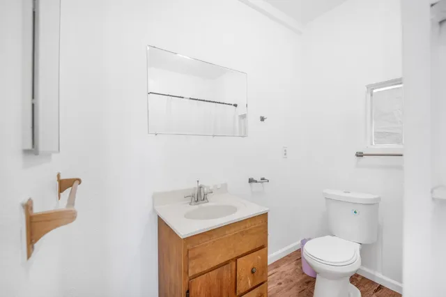 a bathroom with a sink toilet and vanity