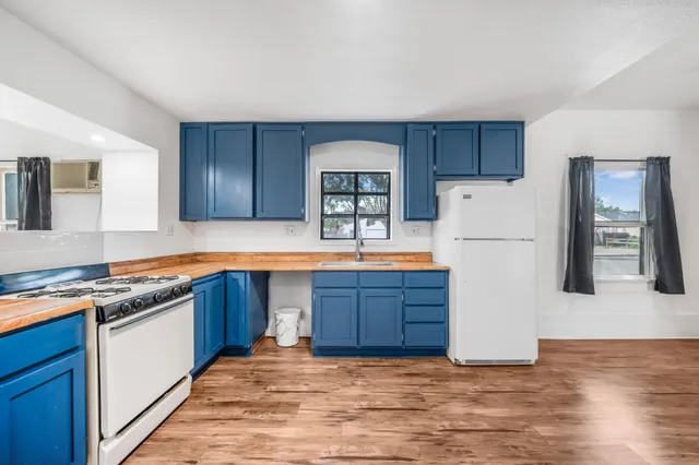 a kitchen with stainless steel appliances granite countertop a refrigerator a stove a sink and a microwave