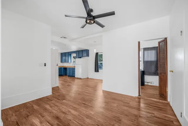 a view of a kitchen with a sink and a refrigerator