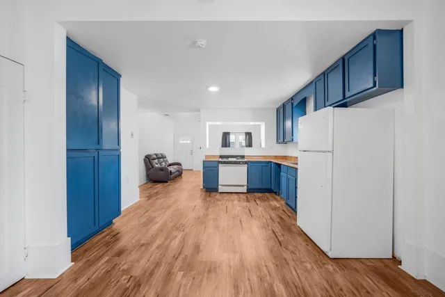 a kitchen with a refrigerator and a stove top oven