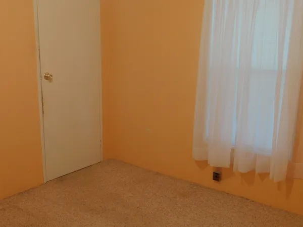 a large white bed in a bedroom