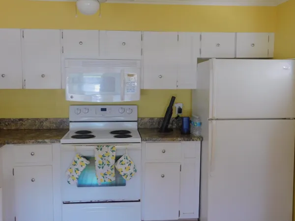 a kitchen with a stove and a refrigerator