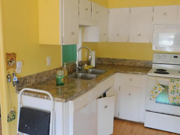 a kitchen with a sink a stove and cabinets