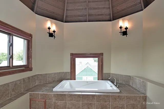 a bathroom with a tub and window