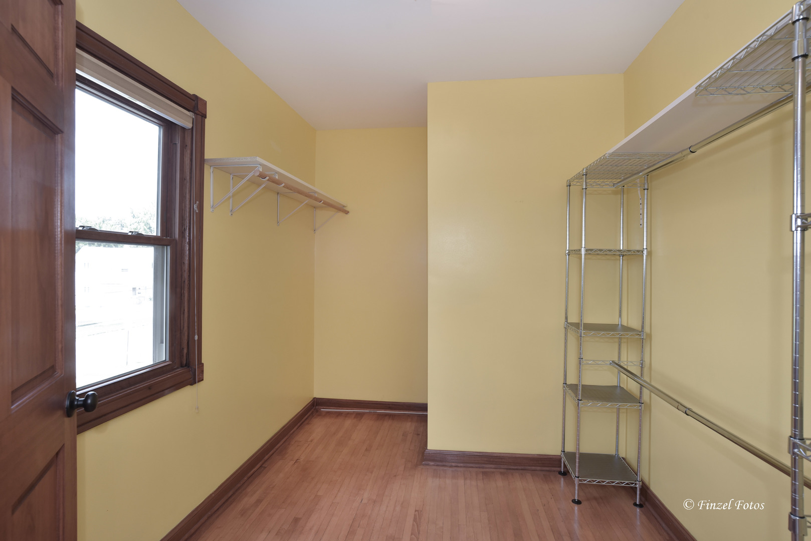 331 Griswold Street Elgin, IL 60123 - Photo 19 of 36 a view of an empty room with wooden floor and a window