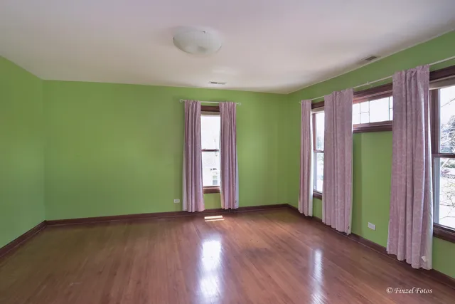 an empty room with closet and a window