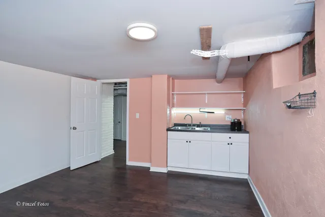 a kitchen with stainless steel appliances a stove and white cabinets
