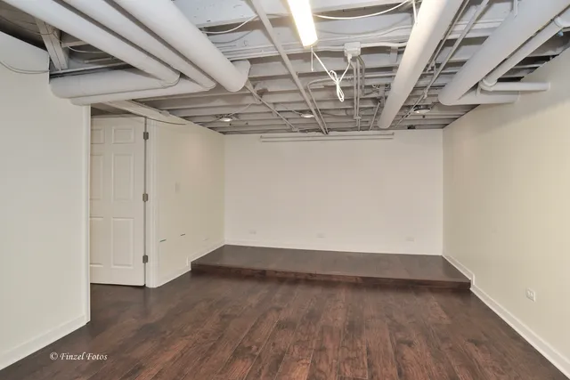 a view of a room with wooden floors and stairs