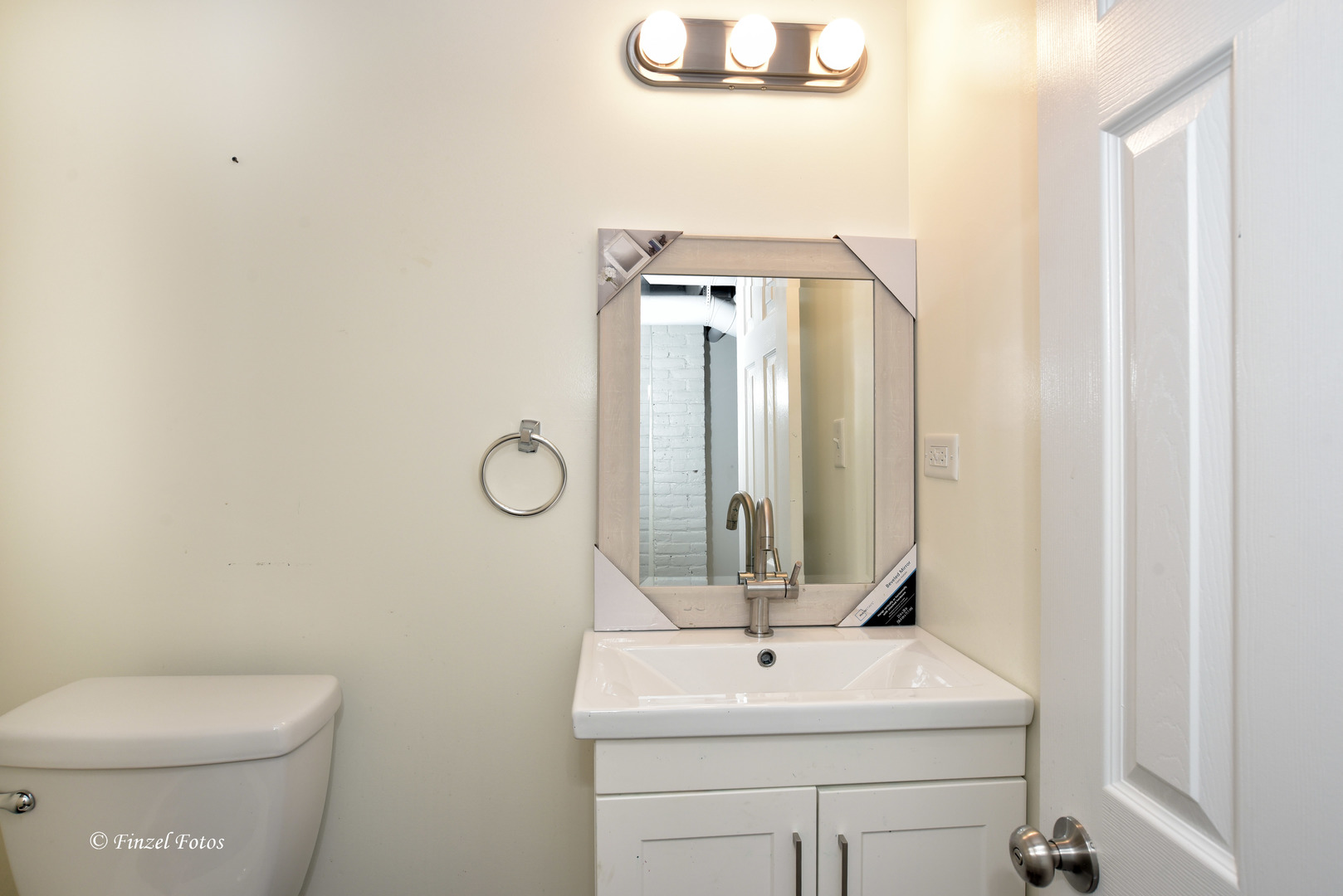 331 Griswold Street Elgin, IL 60123 - Photo 29 of 36 a bathroom with a toilet sink and mirror