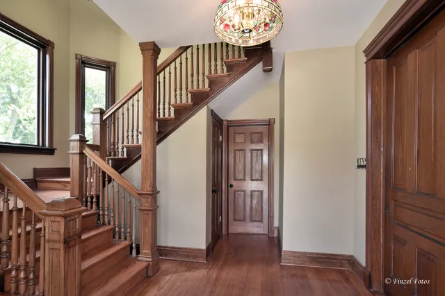 a view of entryway with wooden floor and stairs