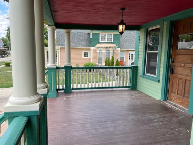 a view of a house with porch and wooden floor