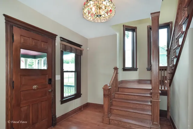 a view of entryway and hall with wooden floor