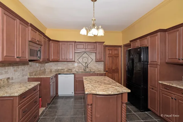 a kitchen with a sink stove and refrigerator