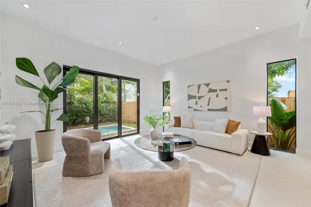 a living room with furniture a flat screen tv and a large window