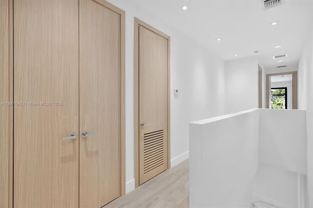 a bedroom with a large bed and a large window