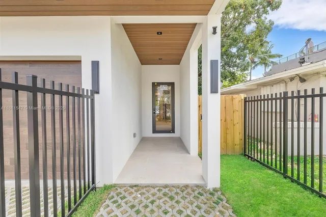 a view of a hallway with wooden floor and fence