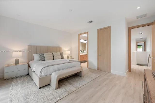 an empty room with wooden floor and window