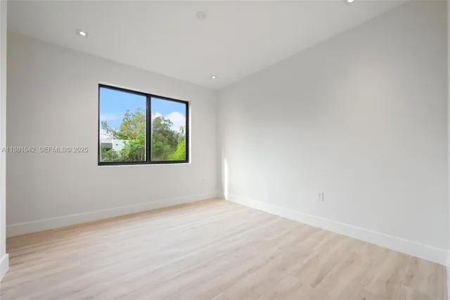 a bathroom with a granite countertop toilet and a sink