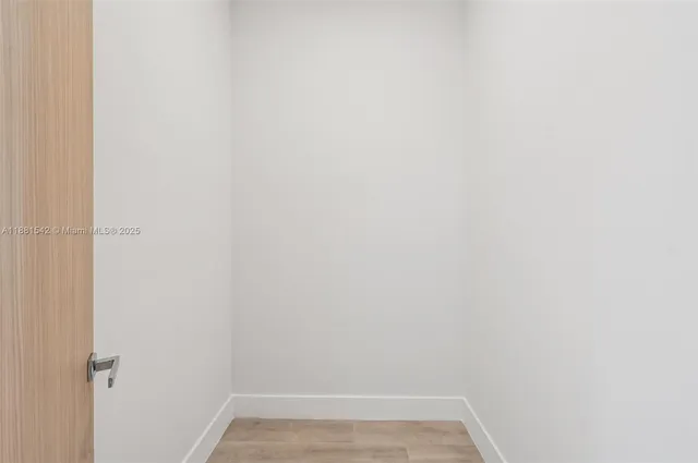 a bathroom with a granite countertop toilet a sink a mirror and shower