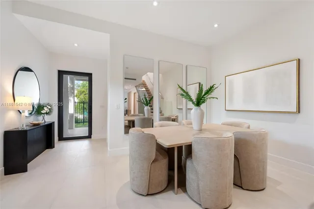 a living room with furniture potted plant and a wooden floor