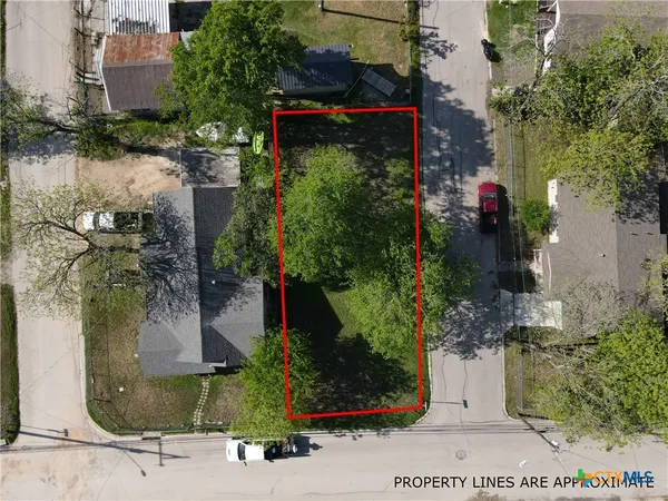 an aerial view of a houses with street