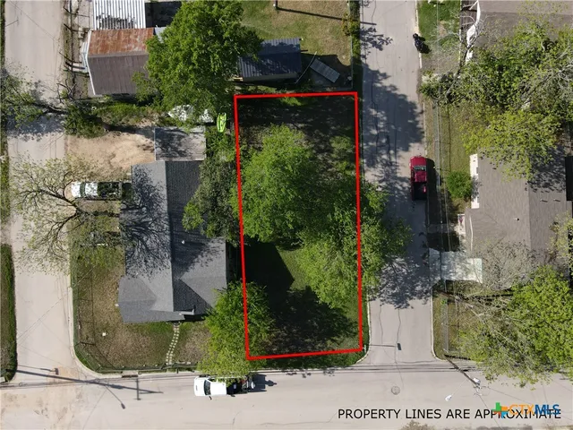 an aerial view of a houses with street