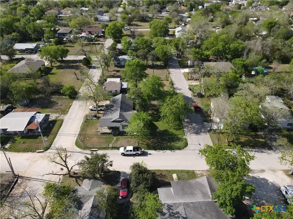an aerial view of residential houses with outdoor space