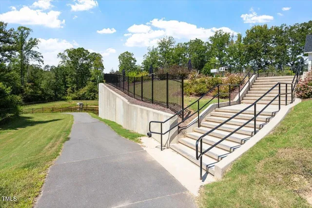 a view of a terrace with trees in the background