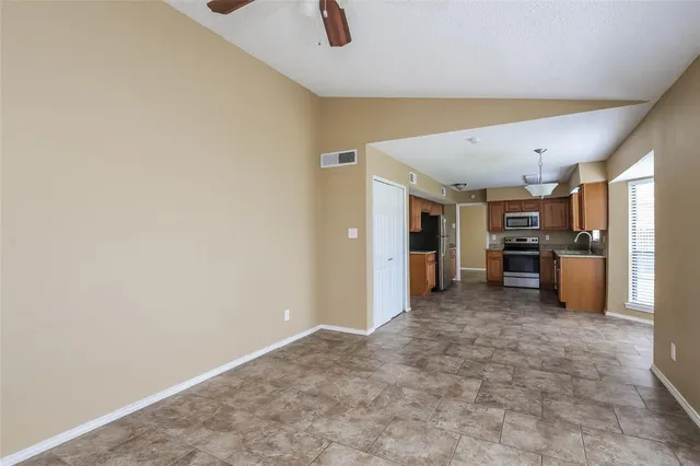 a view of a kitchen with a sink and refrigerator