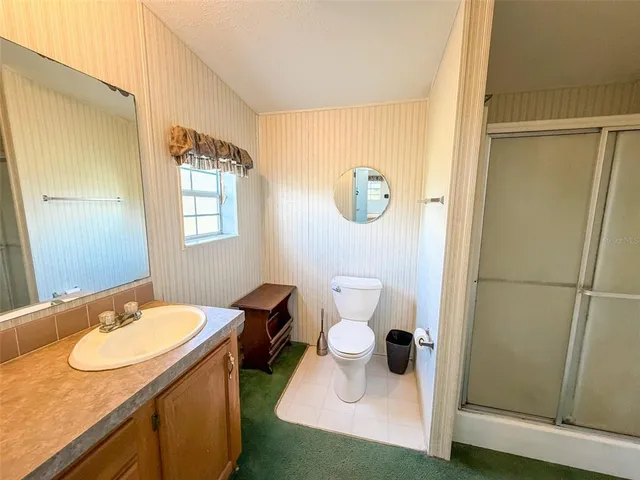 a bathroom with a sink mirror vanity and toilet