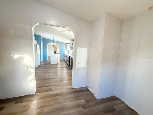 a view of a hallway view with wooden floor and staircase