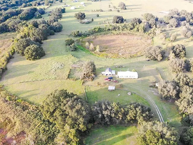 an aerial view of a house with a yard