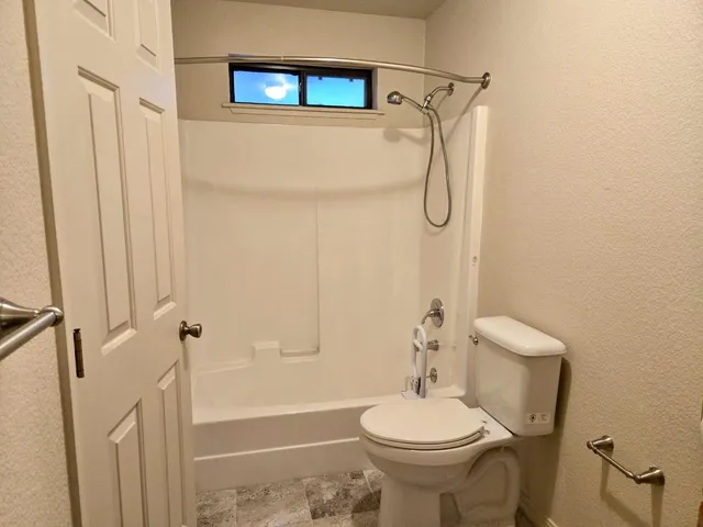 a bathroom with a toilet sink and shower