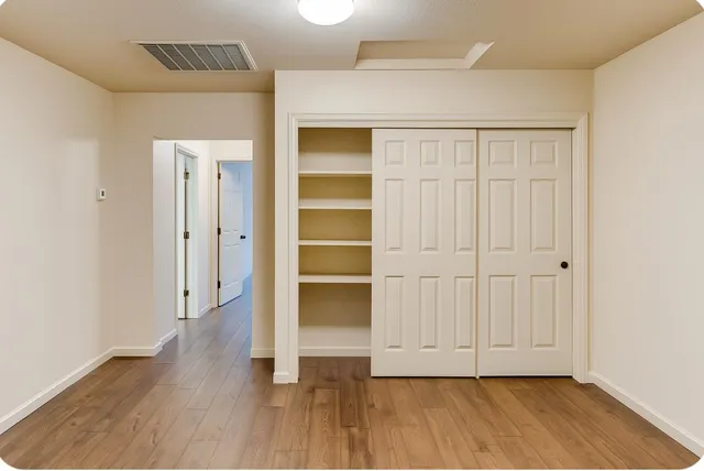 an empty room with wooden floor